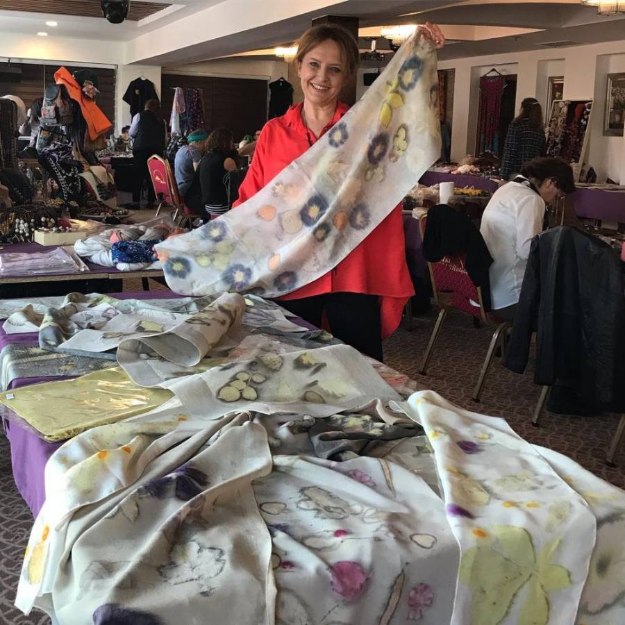 Gülbüz Uç, sunumunda ecoprint ipek şalını gösteriyor